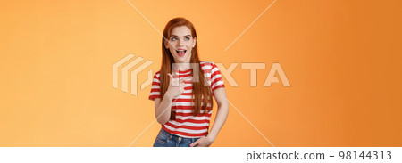 Enthusiastic amazed sassy modern redhead female attend impressive bad awesome design, look amused, observe cool place, pointing left excited, open mouth fascinated intrigued, stand orange background Enthusiastic amazed sassy modern redhead female attend impressive bad awesome design, look amused, observe cool place, pointing left excited, open mouth fascinated intrigued, stand orange background 98144313