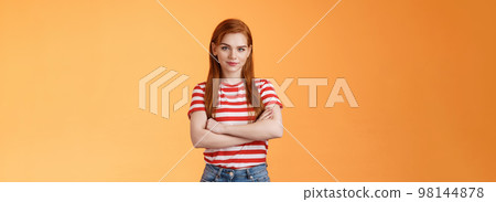 Go on try me. Confident cool redhead daring woman cross arms professional pose, smiling determined motivated win, look assertive and assured own powers, stand orange background 98144878