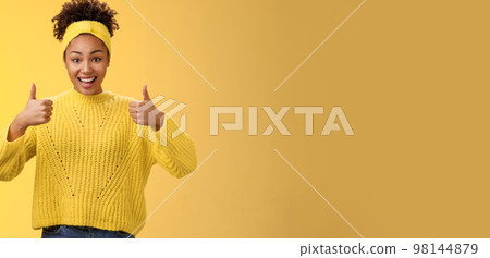 Supportive friendly modern trendy african-american female friend supporting you show thumbs-up keep up good work gesture proud doing best effort, liking result approving plan, yellow background 98144879