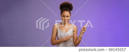 Suspicious intense doubtful unsure elegant smart african-american woman thing something wrong frowning sulking thoughtful express disbelief annoyance pointing upper left uncertain, blue background 98145057