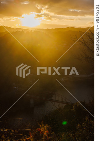 Evening view of Tsukigase in early spring 2023 Orange sky and mountains ⑤ 98145201