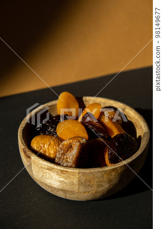 Eco wooden Bowl with different Mix dried fruits apricots prunes figs. Healthy food lifestyle. Vegan dessert snack. shadows Isometric  98149677