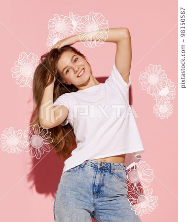 Young beautiful happy girl dancing over tender pink background with floral drawings, sketches. Concept of beauty, art, international women's day, spring, emotions Young beautiful happy girl dancing over tender pink background with floral drawings, sketches. Concept of beauty, art, international women's day, spring, emotions 98150587