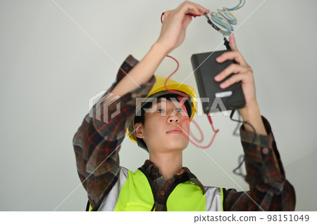 Asian male electrician using a multimeter measuring voltage and current of power electric line Asian male electrician using a multimeter measuring voltage and current of power electric line 98151049