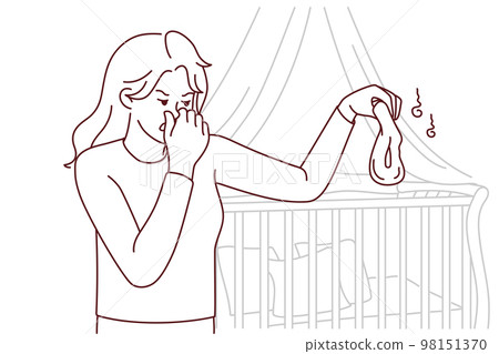 Unhappy mother holding stinky diaper 98151370