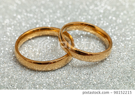 Will you marry me. Two golden wedding rings on silver glitter background. Engagement marriage proposal wedding concept. St. Valentine's Day postcard. Banner on valentines day. Copy space 98152215