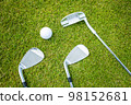 Golf clubs and ball on a green grass, background 98152681