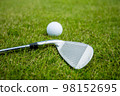 Golf clubs and ball on a green grass, background 98152695