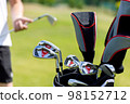 Black golf club bag on the golf course against a background of green grass. High quality photo 98152712