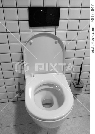 Black and white photo. Modern clean toilet in the public toilet. Hygiene. 98153047