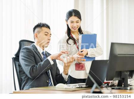 Career woman talking to her boss in the office Career woman talking to her boss in the office 98153154