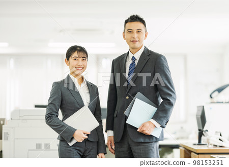 Young male and female business people working in the office Young male and female business people working in the office 98153251