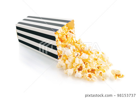 Tasty cheese popcorn falling out of a black striped carton bucket, isolated on white background Tasty cheese popcorn falling out of a black striped carton bucket, isolated on white background 98153737