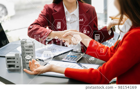 Signing a contract. Client and broker agent, lease agreement, successful deal and Young business sitting at the desk in office Signing a contract. Client and broker agent, lease agreement, successful deal and Young business sitting at the desk in office 98154169