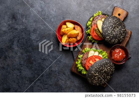 Homemade beef burgers with black buns 98155073