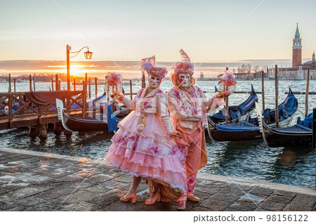 Colorful carnival masks against gondolas at a traditional festival in Venice, Italy Colorful carnival masks against gondolas at a traditional festival in Venice, Italy 98156122