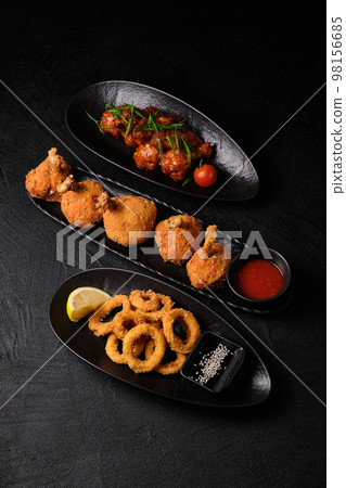 Three plates of snack on black concrete background Three plates of snack on black concrete background 98156685