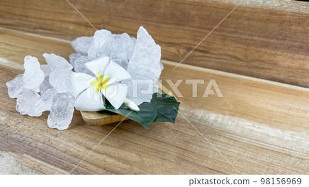 Crystal clear alum cubes or Potassium alum in small wooden dish chemical compound substance concept for beauty spa and underarm treatment industrial Crystal clear alum cubes or Potassium alum in small wooden dish chemical compound substance concept for beauty spa and underarm treatment industrial 98156969