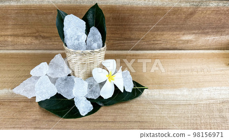 Crystal clear alum cubes or Potassium alum in small wooden dish chemical compound substance concept for beauty spa and underarm treatment industrial 98156971