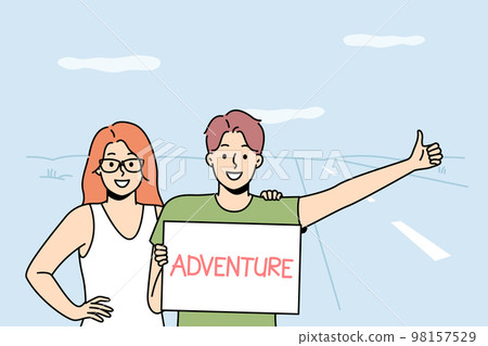 Smiling couple hitchhiking on road 98157529