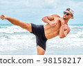 Young healthy man workout exercise on the beach at daytime 98158217