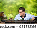 Portrait of handsome agricultural researcher working on research at plantation in industrial greenhouse 98158566