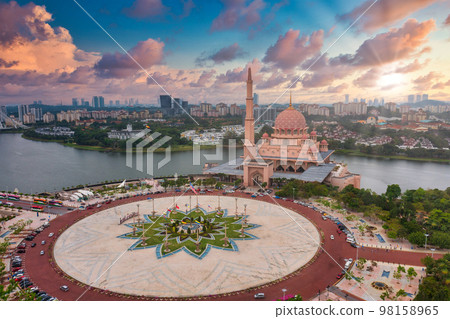 Aerial View Of Putra Mosque with Putrajaya City Centre with Lake at sunset in Putrajaya, Malaysia. Aerial View Of Putra Mosque with Putrajaya City Centre with Lake at sunset in Putrajaya, Malaysia. 98158965