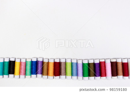 Set of multi-colored skeins of thread on a white background with place for text. Sewing or tailor shop, for advertising Set of multi-colored skeins of thread on a white background with place for text. Sewing or tailor shop, for advertising 98159180
