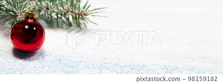 A red Christmas ball and a snow-covered Christmas tree branch on a snowy white background with a place for copyspace text. New Year 2021, holiday card A red Christmas ball and a snow-covered Christmas tree branch on a snowy white background with a place for copyspace text. New Year 2021, holiday card 98159182