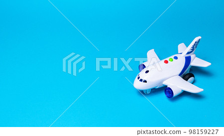 Toy white plane on a blue background banner with a place for text for a toy store and airline companies. Copyspace aircraft airplane. Toy white plane on a blue background banner with a place for text for a toy store and airline companies. Copyspace aircraft airplane. 98159227