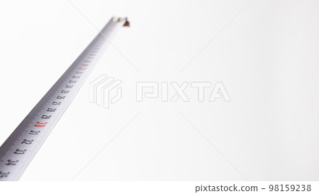 Measuring tape with numbers centimeters on a white background. Construction tools. Banner with place for text 98159238