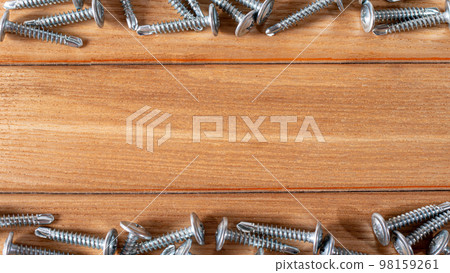 Self-cutters on a wooden background with space for text. Accessories and construction equipment. Banner for construction store and repair 98159261