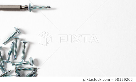 Self-cutters and screwdriver on a white background with space for text. Screw with thread - fasteners for construction, tools and accessories repair 98159263
