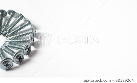 Self-cutters on a white background banner with space for text. Construction tools, self-tapping screws for fastening. Black screw hardware. Self-cutters on a white background banner with space for text. Construction tools, self-tapping screws for fastening. Black screw hardware. 98159264