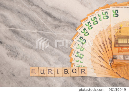 Word EURIBOR Is Written In Wooden Letters, Near Part Of 50 Euro Banknotes. Word EURIBOR Is Written In Wooden Letters, Near Part Of 50 Euro Banknotes. 98159949