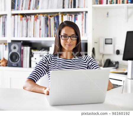 Down to home business. Portrait of an attractive young woman working in her home study. Down to home business. Portrait of an attractive young woman working in her home study. 98160192