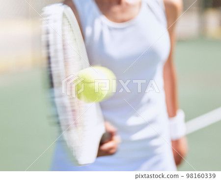 Fitness, tennis and a woman hitting ball with racket or bat on outdoor court with blur movement. Health, wellness and fun with girl on tennis court. Workout, racquet and energy for personal trainer 98160339