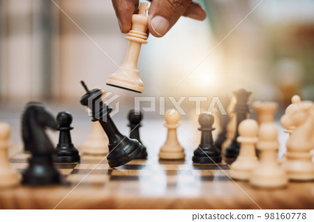 Chess, man and hand with king from board game for winning strategy, tabletop tournament and sports games. Closeup chessboard, checkmate and smart move playing in contest, problem solving or challenge Chess, man and hand with king from board game for winning strategy, tabletop tournament and sports games. Closeup chessboard, checkmate and smart move playing in contest, problem solving or challenge 98160778