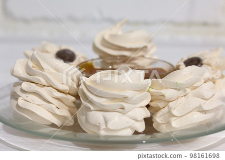 Homemade zephyr. Apricot jam. On a white background. Close-up. 98161698