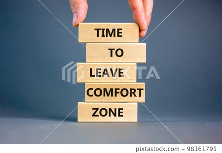 Leave comfort zone symbol. Concept words Time to leave comfort zone on wooden blocks. Businessman hand. Beautiful grey table grey background. Business time to leave comfort zone concept. Copy space. Leave comfort zone symbol. Concept words Time to leave comfort zone on wooden blocks. Businessman hand. Beautiful grey table grey background. Business time to leave comfort zone concept. Copy space. 98161791