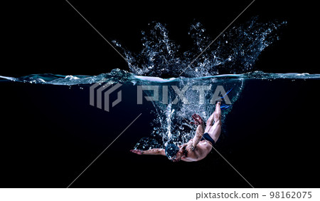 Professional man swimmer on a wave Professional man swimmer on a wave 98162075