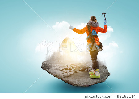 Mountaineer reaches the top of a snowy mountain Mountaineer reaches the top of a snowy mountain 98162114