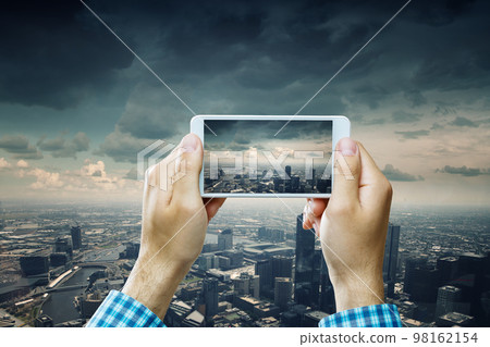 Hand holding smartphone mobile . Mixed media Hand holding smartphone mobile . Mixed media 98162154