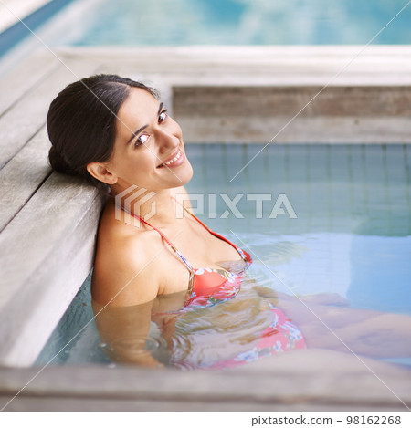 Enjoying a little R and R. an attractive young woman relaxing in a jacuzzi. 98162268