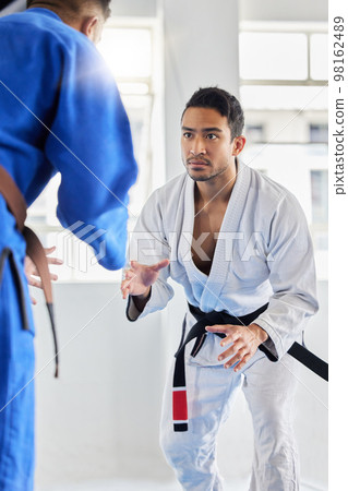 Men, martial arts and karate training in dojo to practice fighting skill. Taekwondo, fitness or self defense class for workout, battle exercise or sports challenge of people in match or competition. 98162489