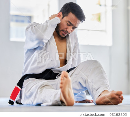 Karate, sports injury and neck pain of man at fitness club for martial arts, exercise and training to fight for competition. Athlete male tired after taekwondo, sport and training with health problem 98162803