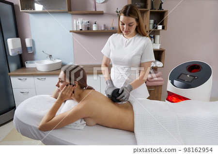 Endosphere therapy of female body by cosmetologist in beauty salon 98162954
