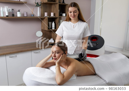 Endosphere therapy of female body by cosmetologist in beauty salon 98163033