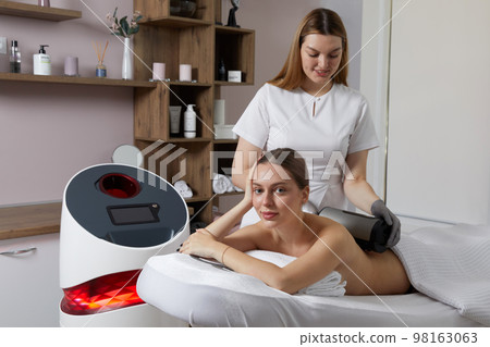 Endosphere therapy of female body by cosmetologist in beauty salon Endosphere therapy of female body by cosmetologist in beauty salon 98163063