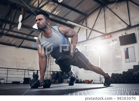 Man fitness dumbbell training, health workout and lifestyle or sport wellness motivation. Focused health athlete, fit active lifestyle and muscle build strength technique with gym exercise equipment 98163070